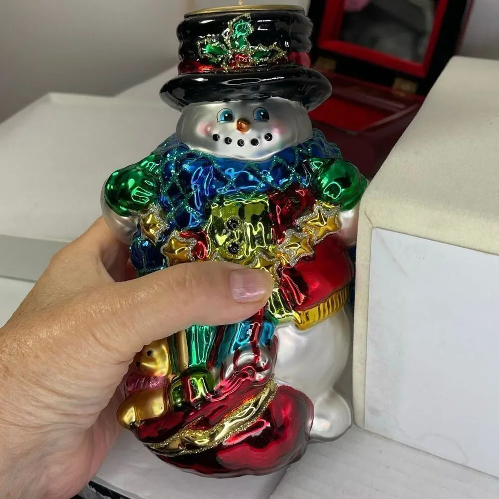 Charming hand-blown mercury glass snowman candle holder.